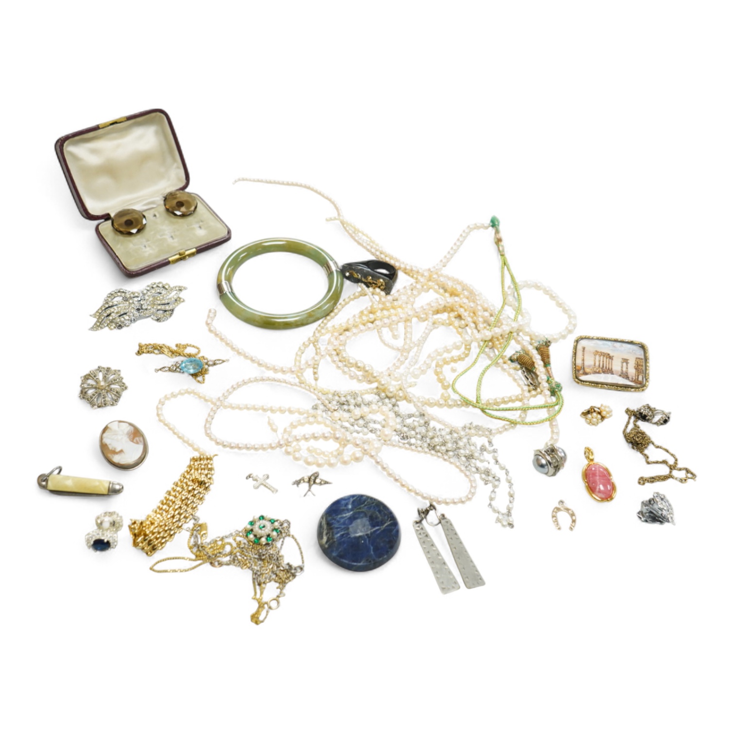 A collection of assorted jewellery including a jade bangle, cultured pearl necklaces and a diamond set yellow metal and quartz ring.